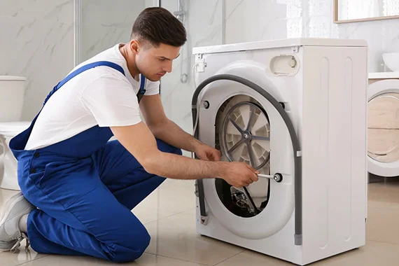 Technician working on a dryer, highlighting the benefits of professional dryer repair services.